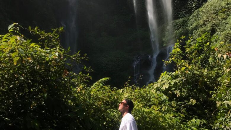 Three Italian guests exploring Sekumpul Waterfalls in North Bali with local guide Sule.