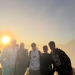 Clients hiking the Mount Batur trail in the darkness with a local guide