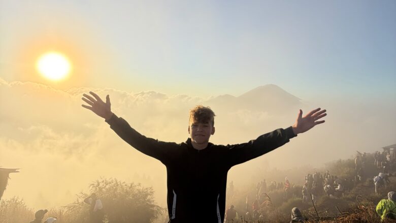 Clients enjoying a beautiful sunrise from the summit of Mount Batur