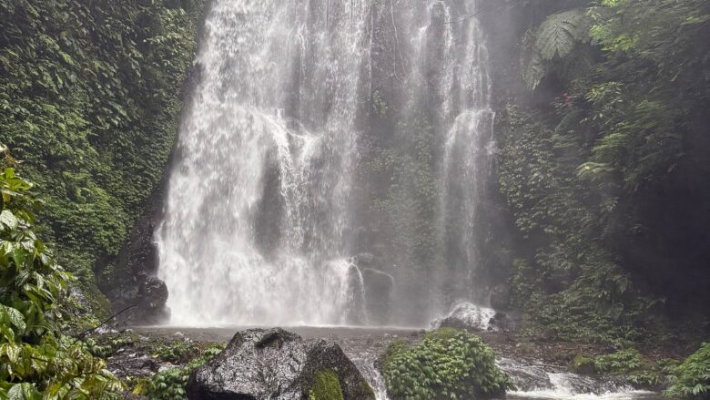 Hikers exploring hidden waterfalls during the Munduk Waterfalls Trek in Bali.