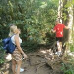 Family exploring the lush tropical forest surrounding Lake Tamblingan in North Bali