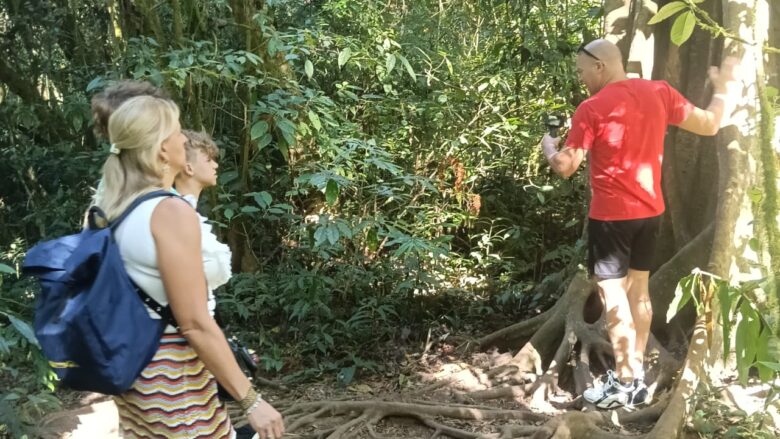 Family exploring the lush tropical forest surrounding Lake Tamblingan in North Bali
