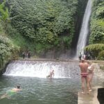 Family continuing their North Bali adventure from the Tamblingan forest toward Munduk Waterfall.