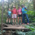 Hikers walking along a rugged forest trail during a Mount Lesung jungle trek