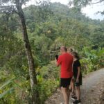 Local guide introducing visitors to coffee, cacao, clove, bamboo, and other tropical plants in Bali.