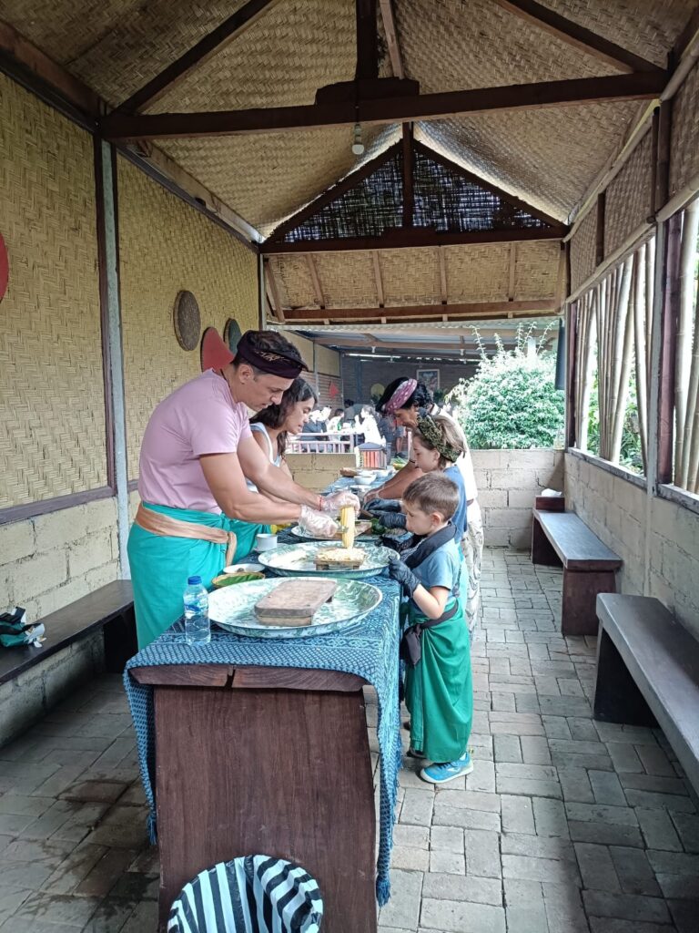 Guests learning traditional Balinese cooking methods with a local village host in Munduk