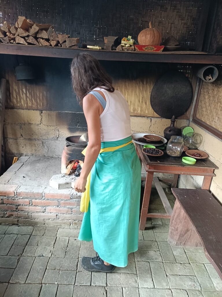 Local host preparing authentic Balinese food using traditional cooking techniques in Munduk